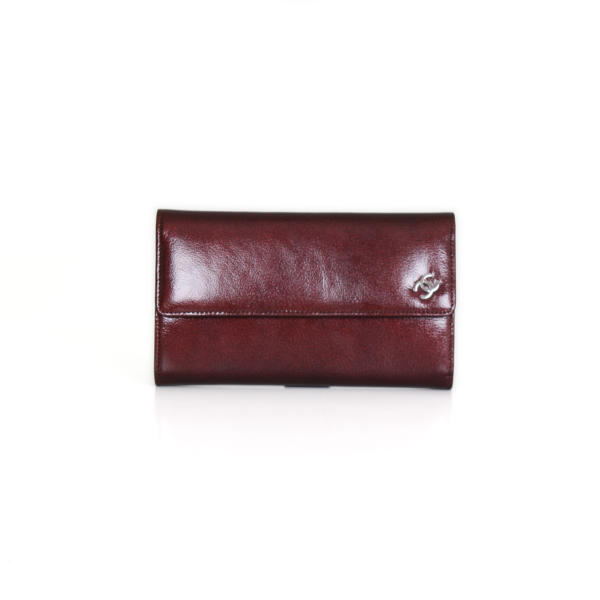Chanel burgundy patent leather front flap wallet.